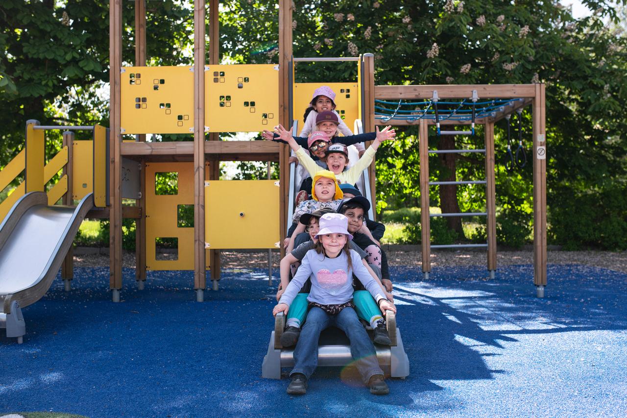 Children in front of stainless steel slide