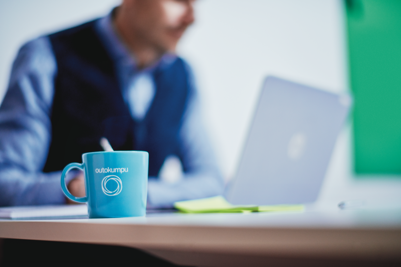 Office worker with a coffee mug and a laptop